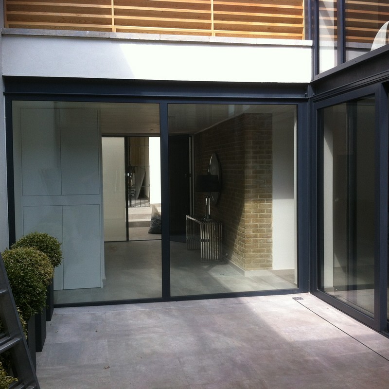 Floor-to-ceiling sliding doors opening to courtyard in Hornsey