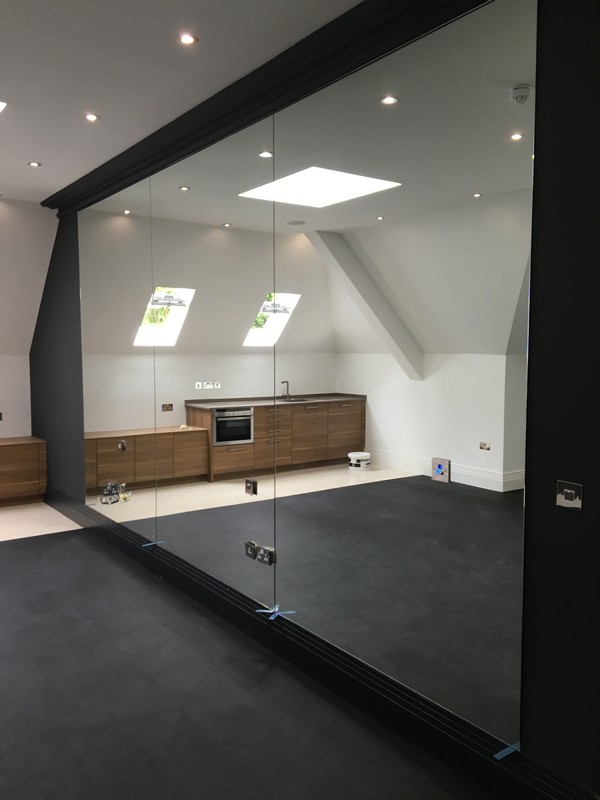 Frameless glass partition in loft conversion by Hornsey glaziers