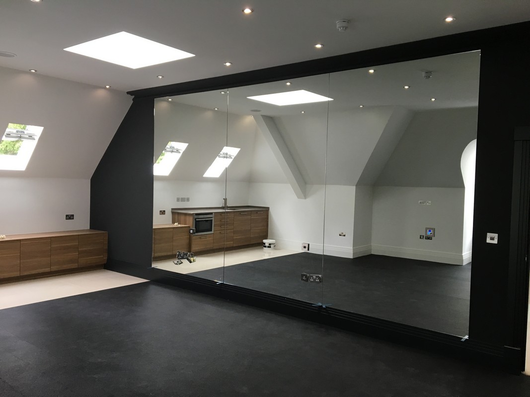 Frameless glass wall dividing loft conversion in Hornsey
