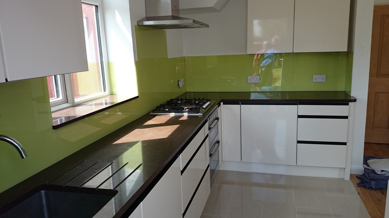 Lime green glass kitchen splashback installed by Hornsey glaziers