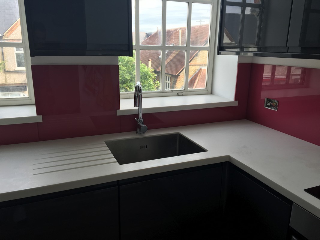 Deep plum coloured glass splashback in modern Hornsey kitchen